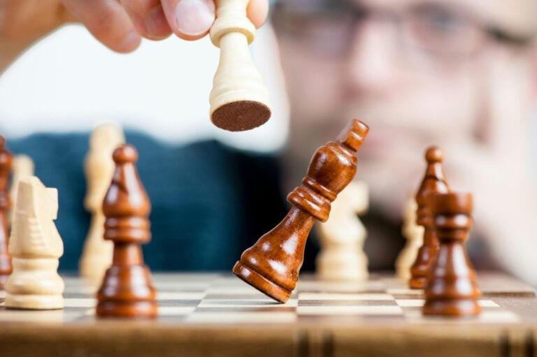 Person planning marketing strategy represented by chess game, capturing decisive move with king piece
