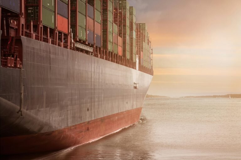 Cargo ship loaded with shipping containers at sea, representing global supply chain logistics