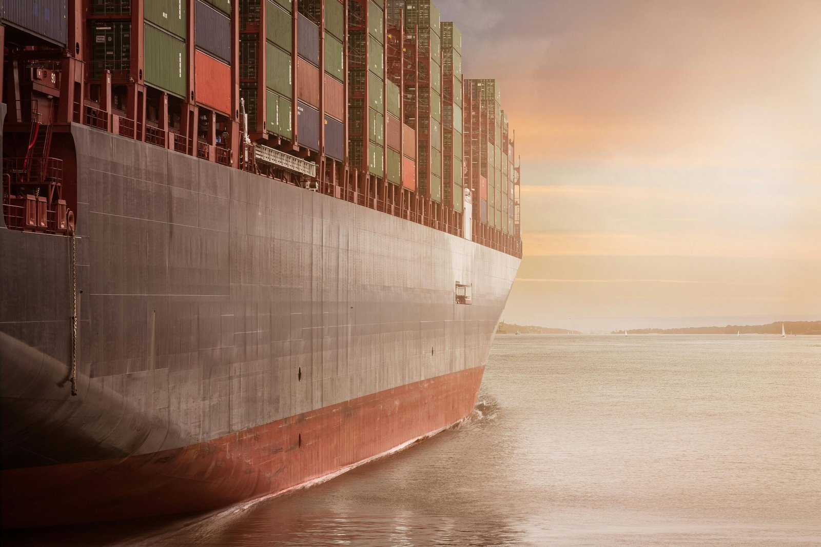 Cargo ship loaded with shipping containers at sea, representing global supply chain logistics